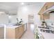 Open kitchen with white countertops, light wood cabinets, and modern appliances at 133 Park Ridge Ln, Henderson, NV 89002