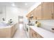 Charming kitchen featuring sleek countertops, white appliances, and light wood cabinets at 133 Park Ridge Ln, Henderson, NV 89002