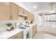 Cozy kitchen featuring light wood cabinetry, modern appliances, and natural light at 133 Park Ridge Ln, Henderson, NV 89002