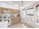 Bright kitchen with light wood cabinets, white appliances, and a sunny breakfast nook at 133 Park Ridge Ln, Henderson, NV 89002