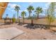 Spacious backyard with pergola, perfect for outdoor gatherings amidst mature palm trees at 1363 Yeager Ave, Las Vegas, NV 89123