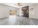 Spacious primary bedroom with stylish accent wall, ceiling fan, and sliding glass door at 1363 Yeager Ave, Las Vegas, NV 89123