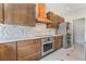 Modern kitchen with stainless steel appliances, stylish range hood, and wooden cabinets at 1363 Yeager Ave, Las Vegas, NV 89123