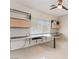 Bright office space featuring custom desk, shelving, and a ceiling fan at 1363 Yeager Ave, Las Vegas, NV 89123