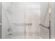 Clean, bright bathroom featuring a tub and shower with glass doors and safety bars at 1363 Yeager Ave, Las Vegas, NV 89123