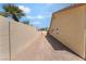 Side yard has ample space along the block wall leading to the backyard, offering potential for various uses at 1363 Yeager Ave, Las Vegas, NV 89123