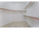 A walk-in closet featuring neutral carpet and shelves for storage and organization at 1363 Yeager Ave, Las Vegas, NV 89123