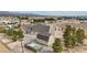 Aerial view showcasing the home, barn, fencing, and trees with neighboring houses in the background at 170 Story Ave, Pahrump, NV 89060