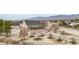 Aerial view of home with front porch and large desert property with mountain views at 170 Story Ave, Pahrump, NV 89060