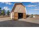 Exterior view of barn featuring an open entrance, wooden door, and natural surroundings at 170 Story Ave, Pahrump, NV 89060