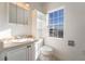 Cozy bathroom with a vanity, toilet, and window offering natural light at 170 Story Ave, Pahrump, NV 89060