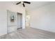 Bright bedroom featuring a ceiling fan, wood floors, and a mirrored closet at 170 Story Ave, Pahrump, NV 89060