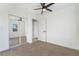 Bright bedroom with carpet, ceiling fan and mirrored closet at 170 Story Ave, Pahrump, NV 89060