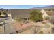 Aerial view of the home showcasing the front exterior, a stone walkway, and mature trees at 170 Story Ave, Pahrump, NV 89060