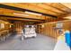 View of an unfinished garage with exposed ceiling beams, concrete floor, built in shelving, and a utility vehicle at 170 Story Ave, Pahrump, NV 89060