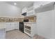 Well-lit kitchen featuring white cabinets, a black gas stove, tile backsplash, and modern finishes at 170 Story Ave, Pahrump, NV 89060