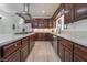 Spacious kitchen featuring dark wood cabinets, stainless steel appliances, and granite countertops at 170 Story Ave, Pahrump, NV 89060