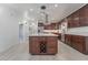 Beautiful kitchen with dark wood cabinetry, stainless steel appliances, large island, and wine rack at 170 Story Ave, Pahrump, NV 89060