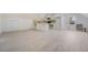 Spacious living room with wood-look floors and convenient kitchenette at 170 Story Ave, Pahrump, NV 89060