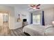 Bright bedroom with a ceiling fan, sliding glass doors to a balcony, and a decorative guitar on the wall at 1713 Queen Victoria St # 104, Las Vegas, NV 89144