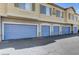Exterior view of garages, showcasing the building's architecture and available parking spaces at 1713 Queen Victoria St # 104, Las Vegas, NV 89144