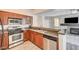 Kitchen with stainless steel appliances next to a fireplace and television at 1713 Queen Victoria St # 104, Las Vegas, NV 89144