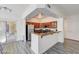 Bright open-concept kitchen featuring a breakfast bar and wood cabinets at 1713 Queen Victoria St # 104, Las Vegas, NV 89144