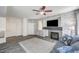 Cozy living room features a decorative fireplace, ceiling fan, and attractive flooring at 1713 Queen Victoria St # 104, Las Vegas, NV 89144