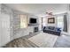 Living room boasts a fireplace, ceiling fan, and wood-look flooring at 1713 Queen Victoria St # 104, Las Vegas, NV 89144