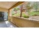 Covered outdoor patio features views of the hillside and mature trees at 1713 Queen Victoria St # 104, Las Vegas, NV 89144