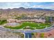 Stunning aerial view of the community clubhouse with pool, landscaping, and mountain backdrop at 2264 Savannah River St, Henderson, NV 89044