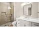 Modern bathroom featuring marble countertop, sleek white cabinetry, and walk-in glass shower at 2264 Savannah River St, Henderson, NV 89044