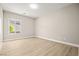 Bright bedroom featuring wood floors, neutral colors, and a window for natural light at 2264 Savannah River St, Henderson, NV 89044
