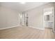 Bright bedroom featuring wood-style floors, neutral colors and doorways to bathroom and closet at 2264 Savannah River St, Henderson, NV 89044