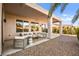 Comfortable outdoor seating under a covered patio overlooking a low maintenance gravel yard at 2264 Savannah River St, Henderson, NV 89044