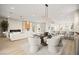 Open-concept living and dining area with modern furnishings and a seamless flow into the kitchen at 2264 Savannah River St, Henderson, NV 89044
