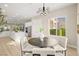 Open concept kitchen and dining area with light hardwood floors and modern light fixtures at 2264 Savannah River St, Henderson, NV 89044