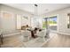 Modern dining room features a stylish light fixture, neutral paint, and views of landscaped yard at 2264 Savannah River St, Henderson, NV 89044