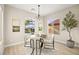Bright dining area with modern light fixture, neutral paint, and views of landscaped yard at 2264 Savannah River St, Henderson, NV 89044