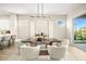 Modern dining room features a stylish light fixture, neutral paint, and views of landscaped yard at 2264 Savannah River St, Henderson, NV 89044