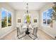 Bright dining area with modern light fixture, neutral paint, and views of landscaped yard at 2264 Savannah River St, Henderson, NV 89044