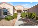 Stunning home with lush bushes, rock landscaping, and a paved walkway leading to the arched entryway at 2264 Savannah River St, Henderson, NV 89044