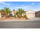 Charming single-story home with a well-manicured front yard, mature palm trees, and a two-car garage at 2264 Savannah River St, Henderson, NV 89044