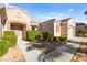 Beautiful home featuring manicured landscaping, stone accents, and a well-maintained lawn leading to the entrance at 2264 Savannah River St, Henderson, NV 89044