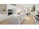 Bright kitchen features a large island with quartz countertops, stainless appliances, and modern white cabinetry at 2264 Savannah River St, Henderson, NV 89044