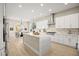 Open kitchen featuring a large island with stone countertop and modern appliances, flowing into the dining area at 2264 Savannah River St, Henderson, NV 89044