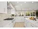 Modern kitchen features white cabinets, stainless appliances, quartz countertops, and large island with open floor plan at 2264 Savannah River St, Henderson, NV 89044
