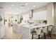Bright kitchen with white cabinets, stainless steel appliances, and a large island with a marble waterfall countertop at 2264 Savannah River St, Henderson, NV 89044