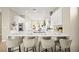 Open concept kitchen features a marble countertop island with barstool seating and modern appliances at 2264 Savannah River St, Henderson, NV 89044