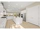 Bright kitchen features a large island with quartz countertops, stainless appliances, and modern white cabinetry at 2264 Savannah River St, Henderson, NV 89044
